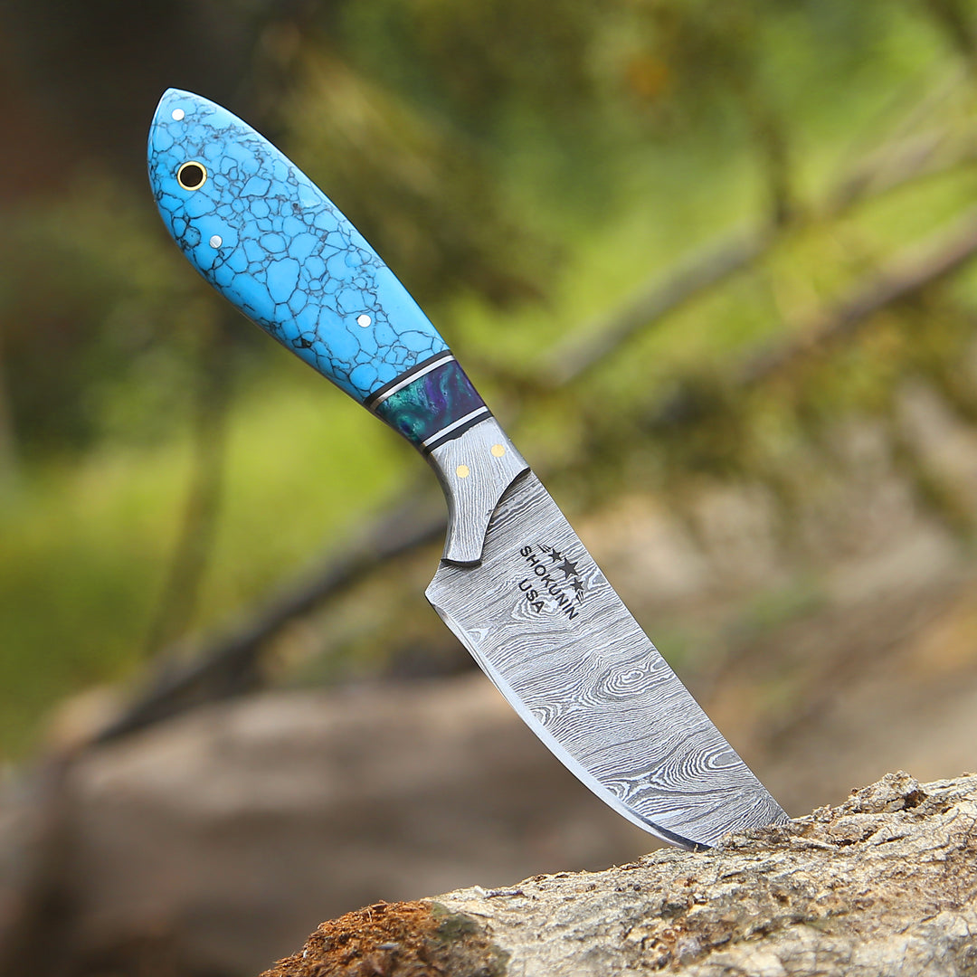 Knife with a blue handle on a natural background