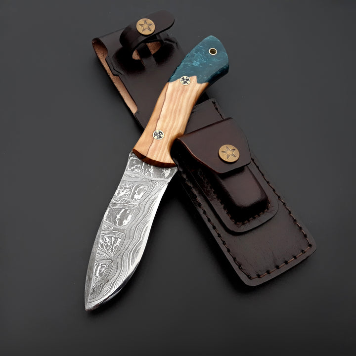 Knife with wooden handle and leather sheath on a dark background