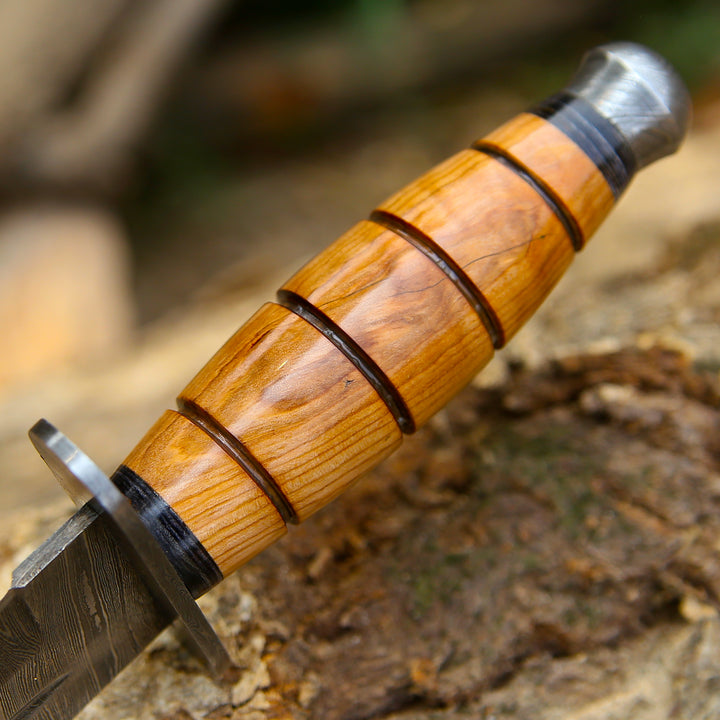 Wooden-handled knife with metal blade on a natural background